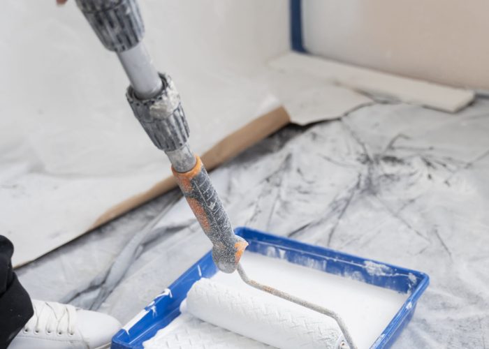 high-angle-contractor-painting-house-wall